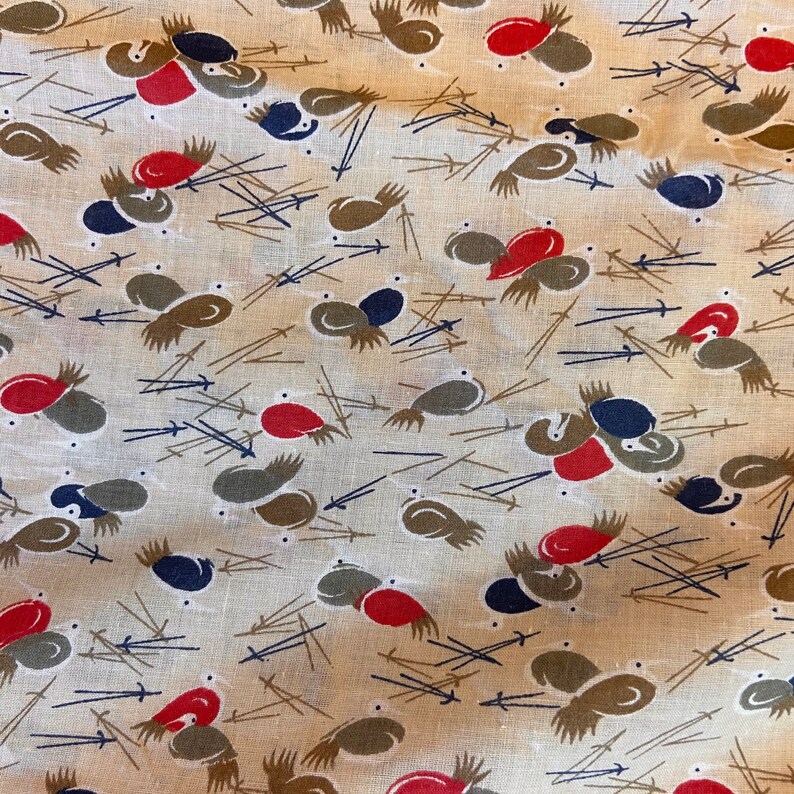 May include: A beige fabric with a repeating pattern of stylized birds in shades of brown, red, and blue. The birds are arranged in a random pattern and are surrounded by thin brown lines.