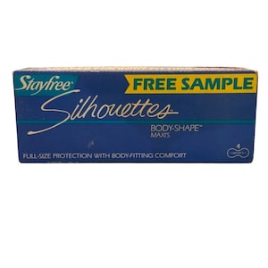 May include: A blue box of Stayfree Silhouettes maxi pads. The box has the words "FREE SAMPLE" in yellow and the words "FULL-SIZE PROTECTION WITH BODY-FITTING COMFORT" in white. The box contains 4 maxi pads.