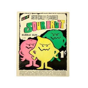 May include: A vintage Leaf Sour Fruit bubble gum wrapper featuring three cartoon monster characters in pink, yellow, and green. The text reads Artificially Flavored Sour Fruit Bubble Gum, L-130, and includes a list of ingredients and manufacturer details.