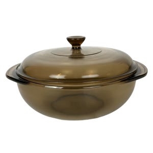 May include: A brown glass casserole dish with a lid. The dish is round and has a knob on the lid.