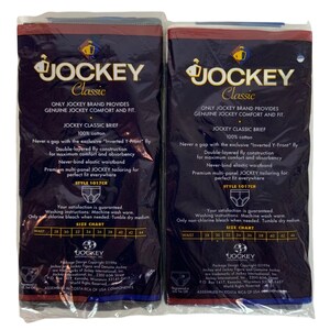 May include: Two packages of Jockey Classic brand underwear. The packages are blue and black with white text. The text on the packages reads "Jockey Classic", "Only Jockey Brand Provides Genuine Jockey Comfort and Fit", "Jockey Classic Brief", "100% Cotton", "Never a gap with the exclusive "Inverted Y-Front" Fly", "Double-layered fly construction for maximum comfort and absorbency", "Never-bind elastic waistband", "Premium multi-panel Jockey tailoring for perfect fit everywhere", "Style 1017CR", "Your satisfaction is guaranteed", "Washing instructions: Machine wash warm. Only non-chlorine bleach when needed. Tumble dry medium.", "Size Chart", "28 30 32 34 36 38 40 42 44".