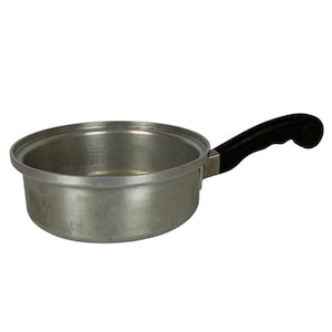 May include: A silver aluminum saucepan with a black plastic handle. The saucepan has a rounded bottom and a straight side.