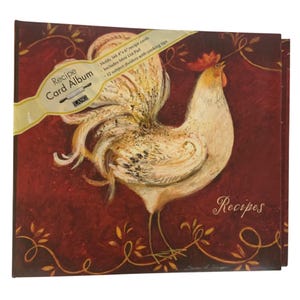 May include: A square recipe card album with a deep red background featuring a white rooster illustration. The cover includes a yellow diagonal banner with the text Recipe Card Album, Holds 144 4x6 recipe cards, Includes Mini List Pad, 12 subject dividers with cooking tips, and the word Recipes in script.