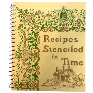 May include: A vintage spiral bound recipe book with a yellow cover and green and brown floral designs. The title is "Recipes Stenciled in Time".