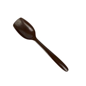 May include: A dark brown spoon with a smooth, glossy finish and a wide, rounded bowl. The handle is slender and tapers toward the end, creating a simple, functional design. The entire utensil is a solid, uniform dark brown color throughout.