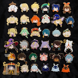 May include: A collection of 36 colorful enamel pins featuring various characters from the popular video game Genshin Impact. The pins are all approximately 1 inch in diameter and feature a variety of designs, including characters, weapons, and symbols from the game.