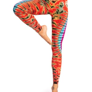 May include: Red, orange, yellow, blue, and black tie-dye leggings. The leggings have a swirling pattern.