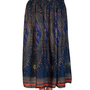 May include: A long, flowing skirt with a dark blue background and an intricate paisley pattern in shades of purple, gold, and orange. The skirt has a smocked waistband and a decorative border at the hem. The skirt is made of a lightweight fabric.