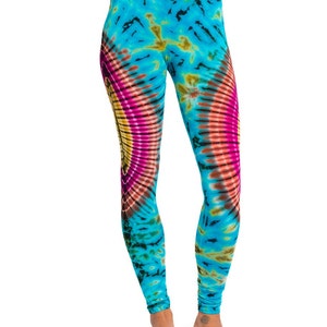 May include: Blue leggings with a colorful tie-dye pattern. The pattern features a large circle with pink, yellow, and orange hues.