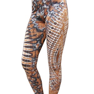 May include: Brown, black, and white patterned leggings with a tie-dye effect.