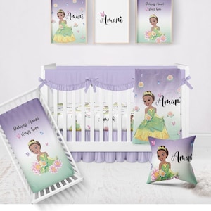 May include: A purple and green baby crib bedding set with a princess theme. The bedding features a cartoon princess with brown skin and a green dress. The bedding also includes a pillow, a fitted sheet, and a blanket. The bedding is personalized with the name "Amani".