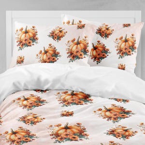 May include: White bedding set featuring a repeating pattern of watercolor pumpkins surrounded by orange and yellow flowers. The set includes two pillowcases and a duvet cover, perfect for autumn decor.
