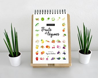May include: A calendar featuring watercolor illustrations of fruits and vegetables. The title is "Calendrier Fruits et Légumes" with the text "aquarelles de Myriam Desclves".