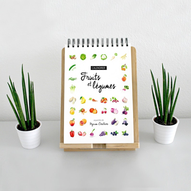 May include: A calendar featuring watercolor illustrations of fruits and vegetables. The title is "Calendrier Fruits et L&eacute;gumes" with the text "aquarelles de Myriam Desclves".