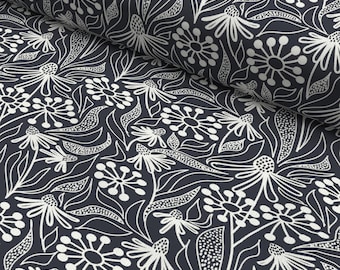 May include: A dark blue fabric with a white floral pattern. The pattern features stylised flowers and leaves.