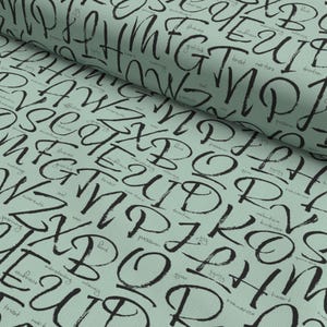 Tissu en coton « Alphabet of Love » avec motifs de lettres vert menthe – par snoozeboo