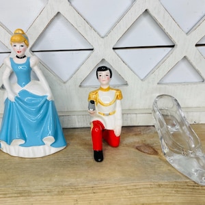 May include: A set of three ceramic mugs with a speckled, matte finish. The mugs are in shades of cream, light brown, and dark brown. Each mug has a simple, minimalist design, perfect for coffee or tea.