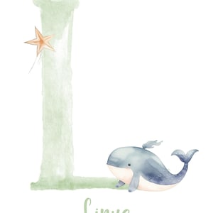 May include: A watercolor illustration of the letter L in green with a small orange star above it. A blue whale with a white belly is swimming below the letter. The name Linus is written in green below the whale.
