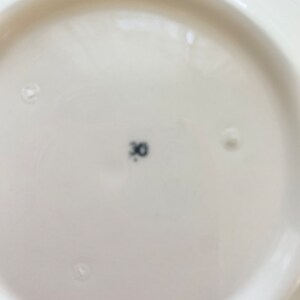May include: The bottom of a white ceramic plate with a black number "30" printed on it.