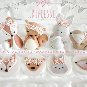May include: Woodland fairy animal cake toppers. A set of 8 fondant toppers featuring a fox, squirrel, bunny, and deer. Each topper has a pink flower crown. The toppers are perfect for a woodland themed party.