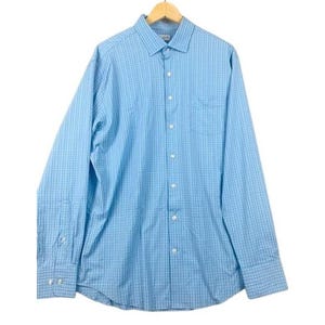 May include: A light blue button-down shirt with a checkered pattern. The long-sleeved shirt has a chest pocket and is hanging on a wooden hanger. The shirt is made of a lightweight fabric.
