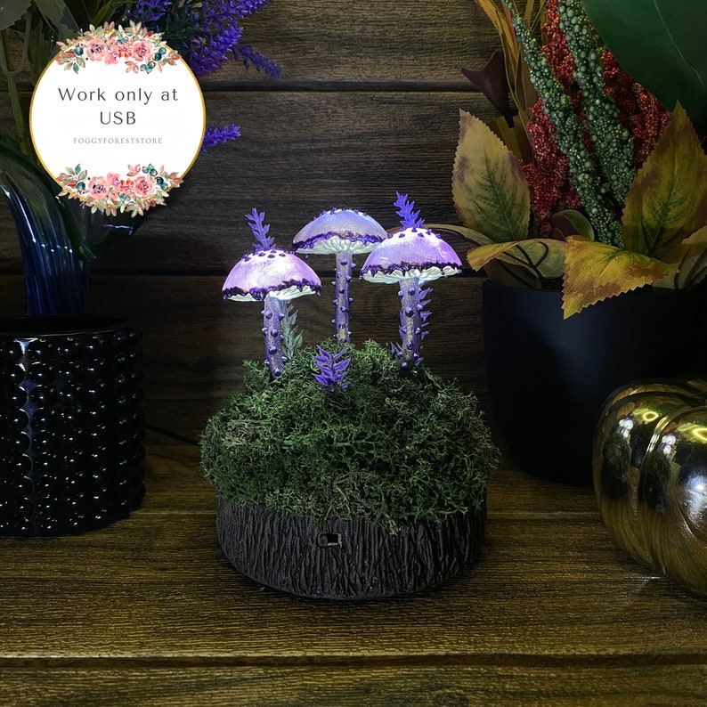 May include: Three purple and white glowing mushroom lamps with a mossy base and a tree trunk design. The lamps are lit up and have a magical fairy tale feel. The text "Work only at USB" is visible in the image.