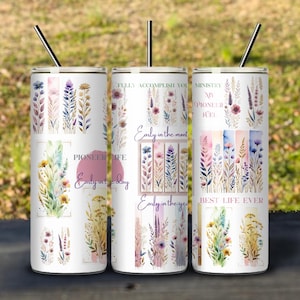 May include: Three white stainless steel tumblers with floral designs and inspirational quotes. The quotes are "Early in the day", "Early in the month", and "Best Life Ever".