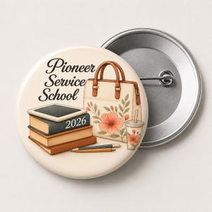 May include: A round button with the text "Pioneer Service School 2026" and illustrations of books, a handbag, a drink, and a pencil. The button has a light beige background and a silver metal backing.