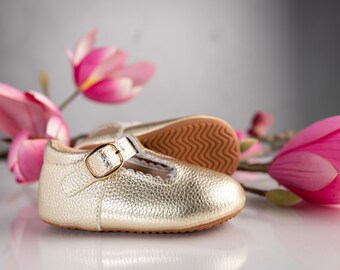 pink and gold baby shoes