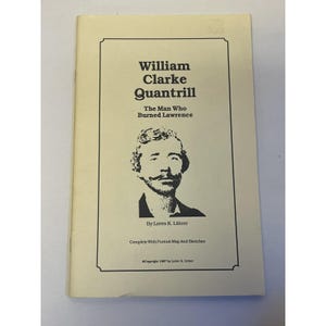 May include: A vintage paperback book titled "William Clarke Quantrill: The Man Who Burned Lawrence." The cover features a black and white portrait and text within a cream-colored border. Includes the author's name and copyright information.
