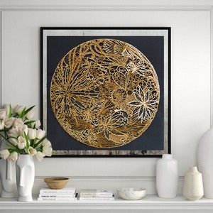 May include: A gold and black framed wall art piece featuring a circular design of gold metallic flowers and leaves on a black background.
