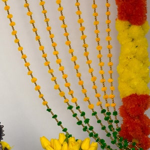 Red green yellow color in one Pompom garlands for door or window decoration, Indian Diwali and Wedding party backdrop