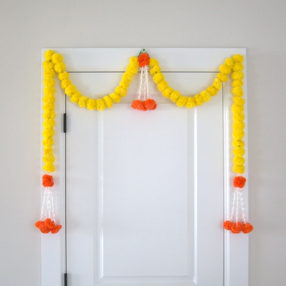 Yellow marigold garlands with orange jasmine short hangings.