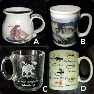 May include: Four different ceramic mugs. The first mug is white with brown speckles and a pink and blue sailboat design. The second mug is white with a blue and green fish design. The third mug is clear glass with an etched moose design and the text "Twin Bridges Montana". The fourth mug is white with a green, brown, and black fly fishing lure design and the text "Blae & Black", "Grafham Hopper", "Grey Duster", "American Black Gnat", "Hares-Face Midge", and "Lunn's Caperer".