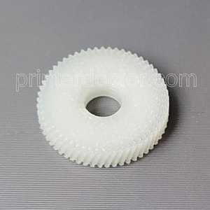 May include: A white plastic gear with a central hole and toothed outer edge. The gear is set against a gray background, with the text "printerdoctor.com" visible.