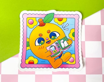 May include: A cartoon orange with a friendly face is reading a book titled "Juiced" with a picture of a bicep on the cover. The orange is surrounded by pink and yellow flowers and a blue sky background. The image is framed with a pink and white border.