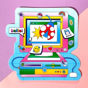 May include: A colorful sticker of a computer with a ladybug on the screen. The computer has a pink and blue case with a yellow keyboard and a green mouse. The sticker has the words "hello!" and "save!" on it.