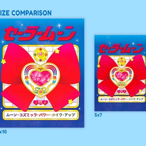 May include: A size comparison of two prints featuring a red bow with a gold heart-shaped brooch. The larger print is 8x10 inches and the smaller print is 5x7 inches. Both prints feature the Japanese text "セーラームーン" which translates to "Sailor Moon".
