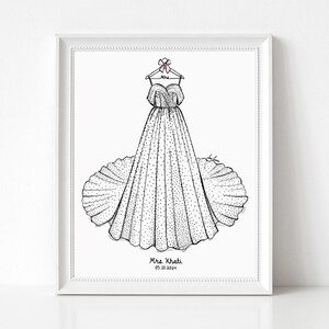May include: A framed black and white line art illustration of a strapless gown with a full skirt and polka dot pattern, hanging on a hanger with a pink bow. The text Mrs. Khati and 05.10.2024 is printed at the bottom of the white paper.