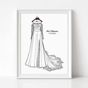 May include: A framed line art illustration of a strapless wedding dress with long lace sleeves, a side slit, and a train. The dress hangs on a hanger with red roses and the text Mrs. The print includes the text Mrs. Robinson and 11/21/2026.