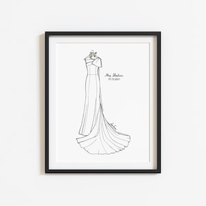 May include: A black and white line art illustration of a one-shoulder gown hanging on a hanger with a small floral detail. The text Mrs. Sheehan and 05.31.2024 are printed to the right of the dress. The artwork is displayed in a black frame.