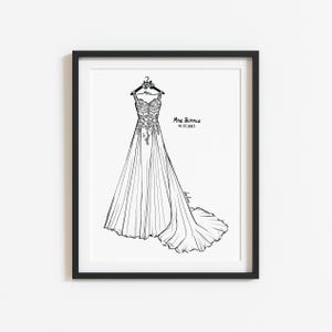 May include: A black and white line art illustration of a wedding dress hanging on a hanger, framed in a black border. The dress features floral lace detailing on the bodice and a long skirt. Text reads Mrs. Burris and 02.15.2025.