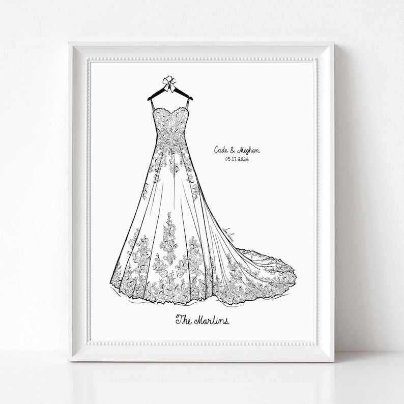 May include: A framed black and white line art illustration of a strapless wedding dress with a long train hanging on a hanger. The text reads Cade & Meghan 05.17.2026 and The Martins. The dress features intricate floral lace detailing.