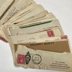 May include: A stack of vintage envelopes with various stamps, including a 10 cent stamp with a red eagle design. The envelopes are addressed to Luxor Limited, Chicago, Illinois. The text "IF NOT DELIVERED IN FIVE DAYS, RETURN TO AMERICAN SCREW COMPANY 219 W. RANDOLPH ST. CHICAGO, ILL." is printed on the envelope.