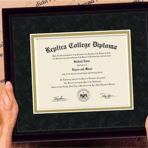 May include: A black framed diploma with a gold border. The diploma reads "Replica College Diploma" and includes the name "Student Name" and the text "Degree and Major".