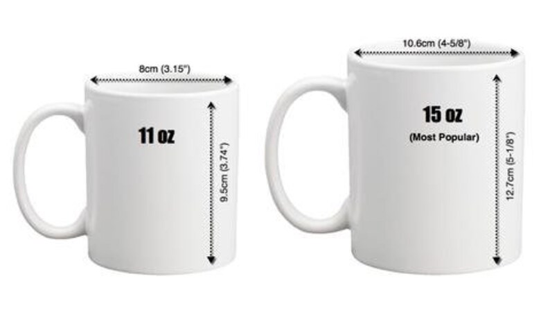 May include: Two white ceramic mugs with black text. The mug on the left is 11 ounces and the mug on the right is 15 ounces. The mugs are shown next to rulers with measurements in inches and centimeters.