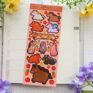 May include: A sheet of horse-themed stickers featuring cartoon horses in brown, orange, pink, and purple. The stickers include apples and carrots. The word "HORSES!" is printed at the top.