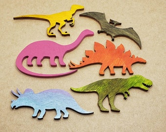 Dinosaur magnets: T-Rex, Stegosaurus, Pterodactyl, Brontosaurus. You choose or get the whole set. Wooden Dino Magnet Set.