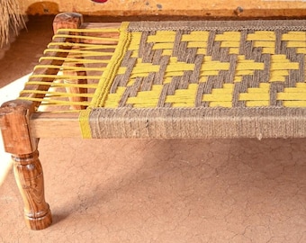 May include: A wooden bed frame with a woven rope mattress. The rope is woven in a checkered pattern with yellow and brown rope.