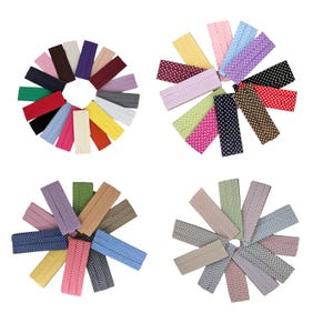 May include: Assortment of 12 different colored elastic hair ties with white polka dots. The hair ties are arranged in a circle.